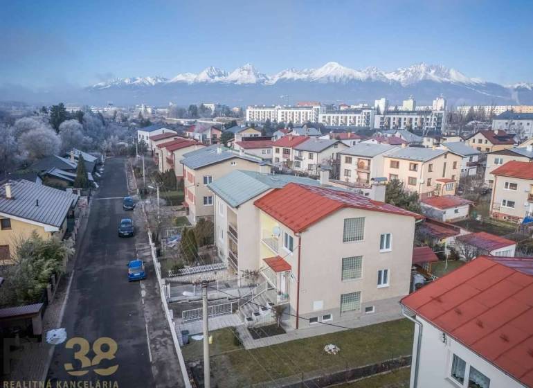 A view of terraced family houses in Poprad with the panorama of the Tatras in the background.