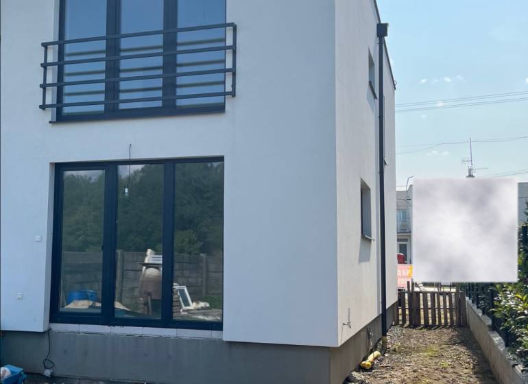 A family house on Zvončín Street in Zvončín with a grassy area in front of the building.