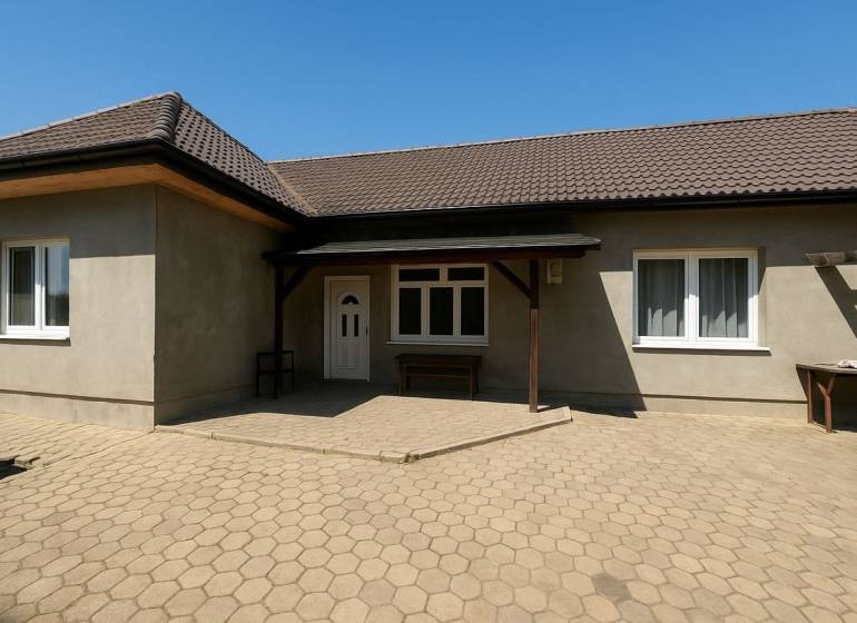 A family house in Tešedíkovo with a gabled roof and a paved courtyard.