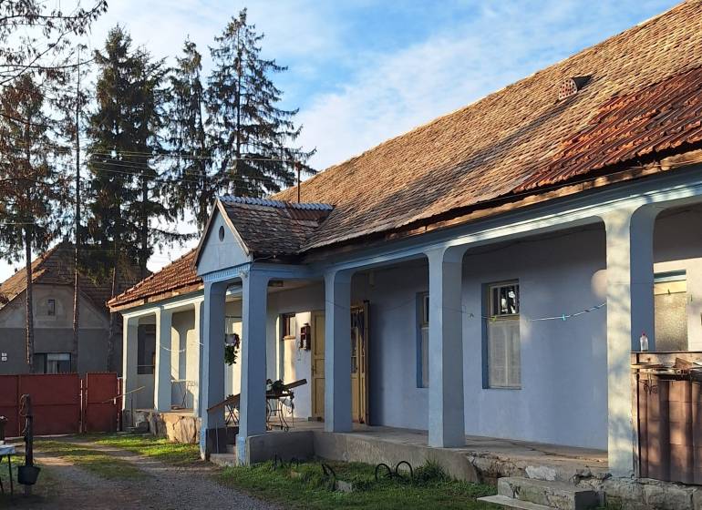 A family house in Rapovce with a gable roof and blue facade.