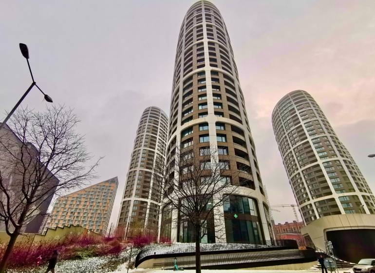 High-rise buildings on Bottova Street in Bratislava - Old Town, snowy surroundings and trees.