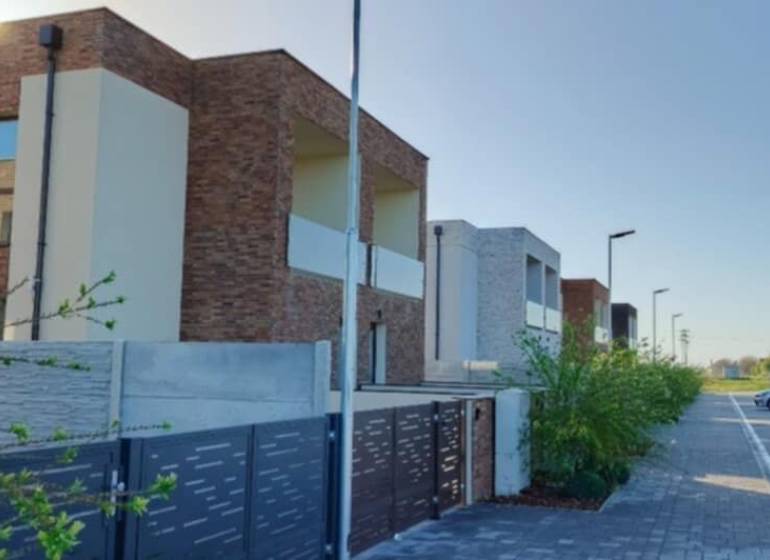 Modern apartment buildings in Diakovce with private parking and landscaped greenery.