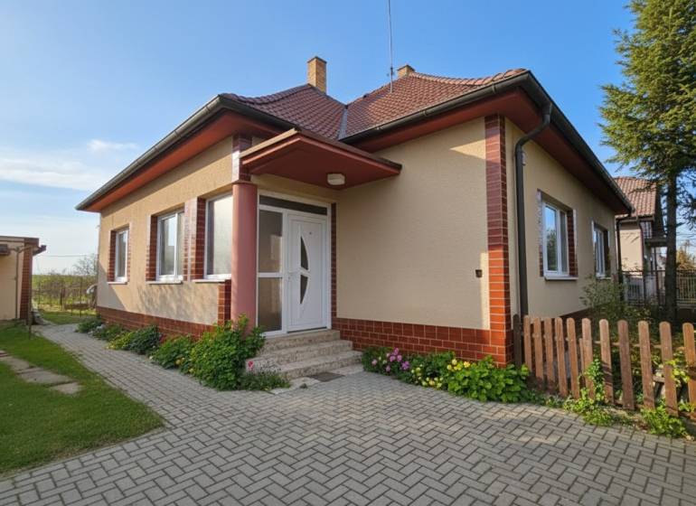 A family house in Križovany nad Dudváhom with a landscaped garden and a paved walkway.
