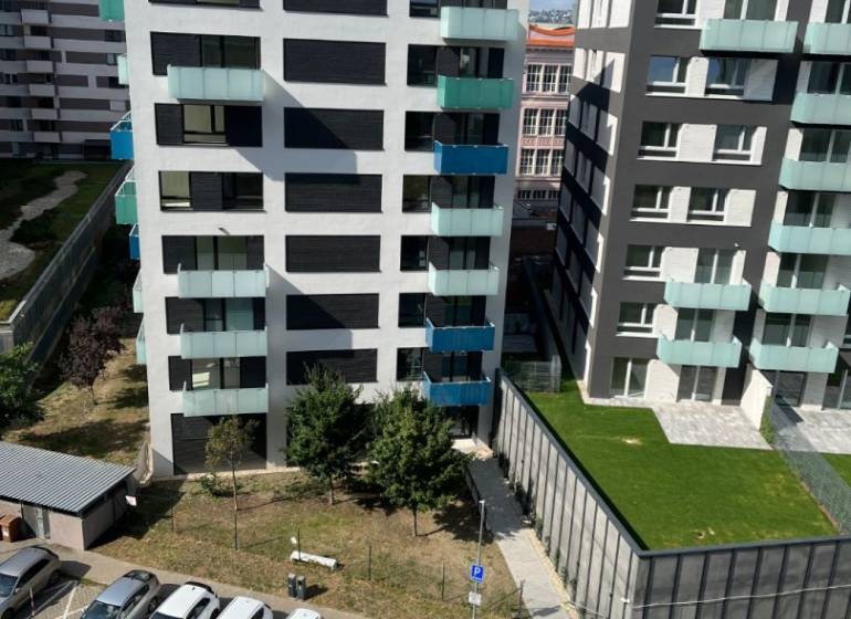 View of modern apartment buildings with parked cars on Jégého Street, Bratislava - Nivy.
