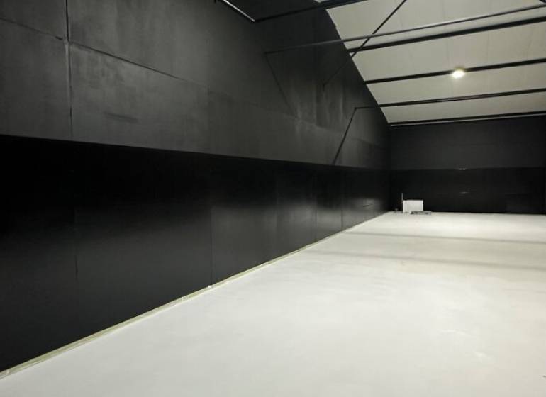 The interior of garages with black walls and a light floor in Sady nad Torysou.