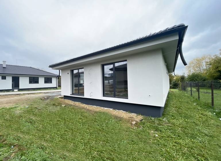 A family house in Prešov with a garden and large windows, featuring spacious and bright interiors.