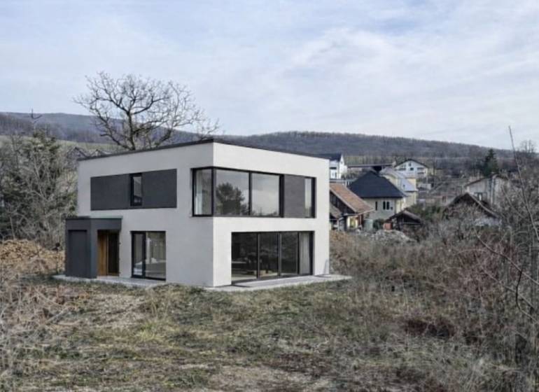 House in Residential Land - surrounded by nature in the town of Nováčany, with hills in the background.