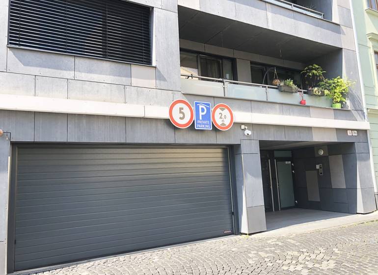 Garages on Jozefská Street in Bratislava - Old Town with warning signs.