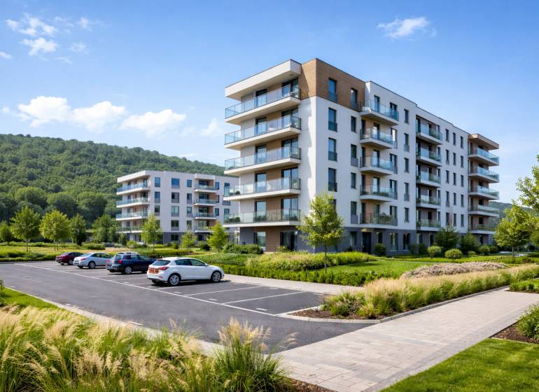 A new building with balconies and parking in Bytča, surrounded by natural scenery.