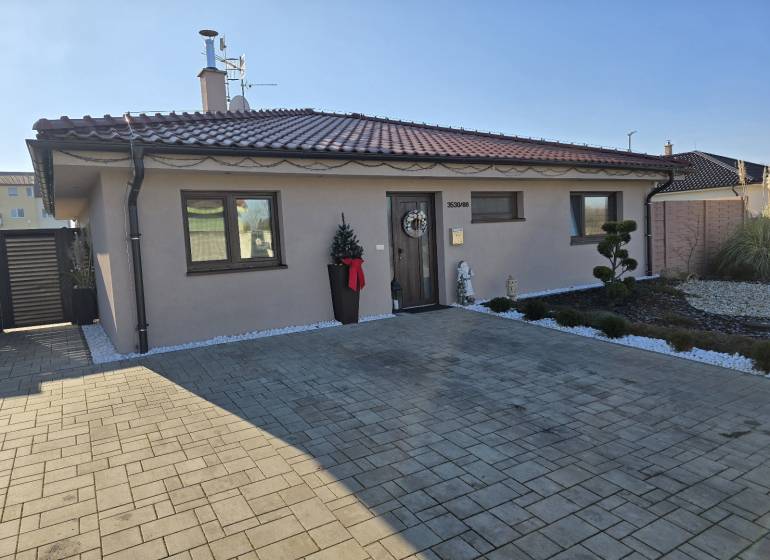 A family house on M. Terézie Street in Holíč with a neatly maintained front garden.