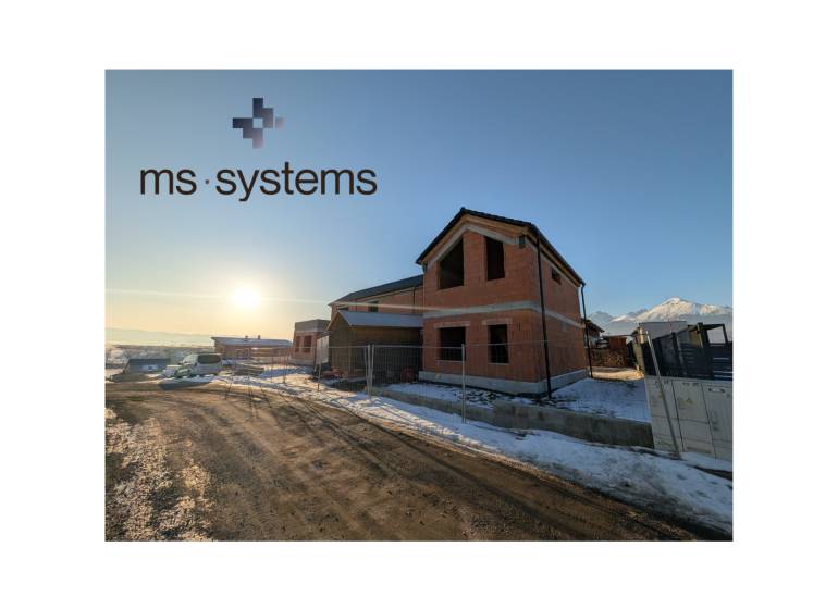 A family house in Mlynica under construction under a blue sky, with a snowy surroundings.