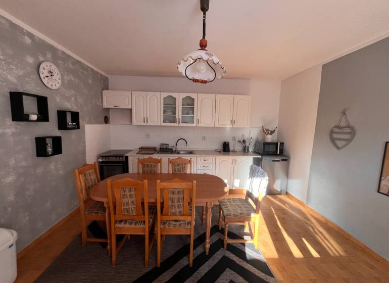 A kitchen in a family house with wooden furniture and a floor with a wooden decor.