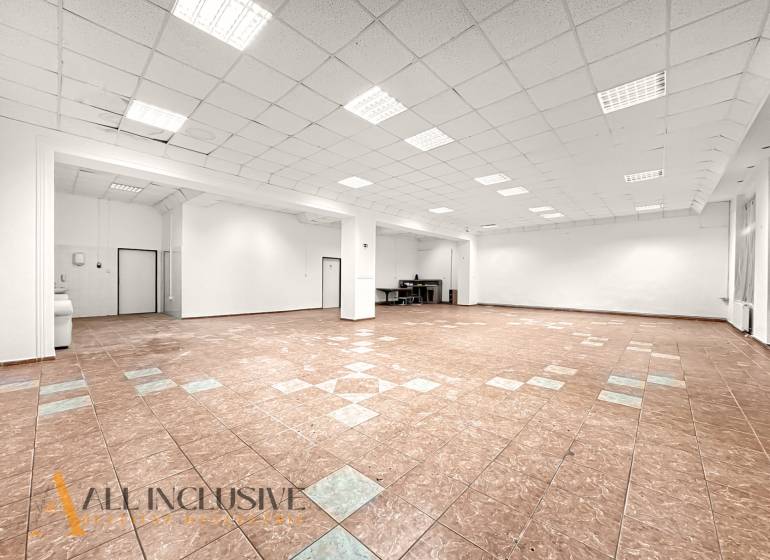 Spacious commercial premises with ceramic tiles and white walls.