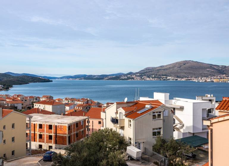 View of Trogir with the coastline and rooftops of houses, ideal for a 3-bedroom apartment.