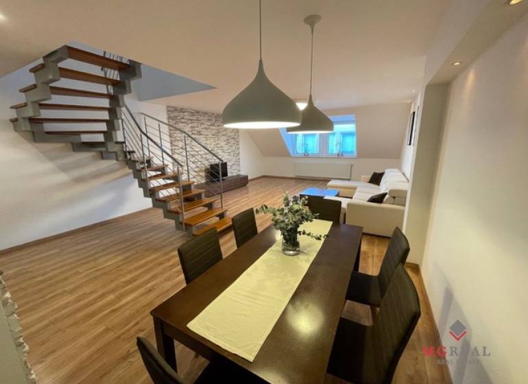 Dining room and living room with wood-patterned flooring in a 3-room apartment.