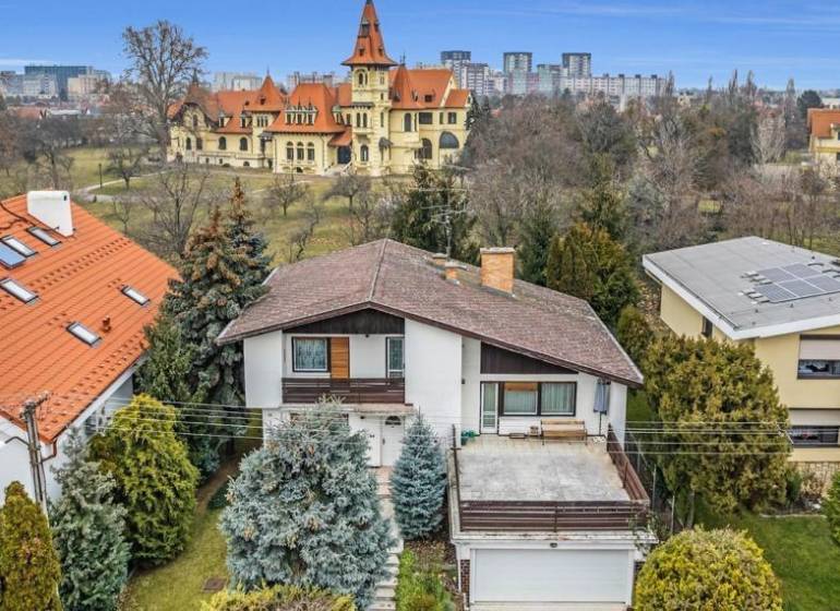 A family house on Fibichova Street in Bratislava - Ružinov surrounded by greenery and with a view of the buildings.