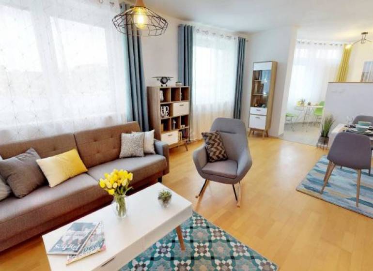 2-room apartment with wood-patterned flooring, bright living area with dining space.