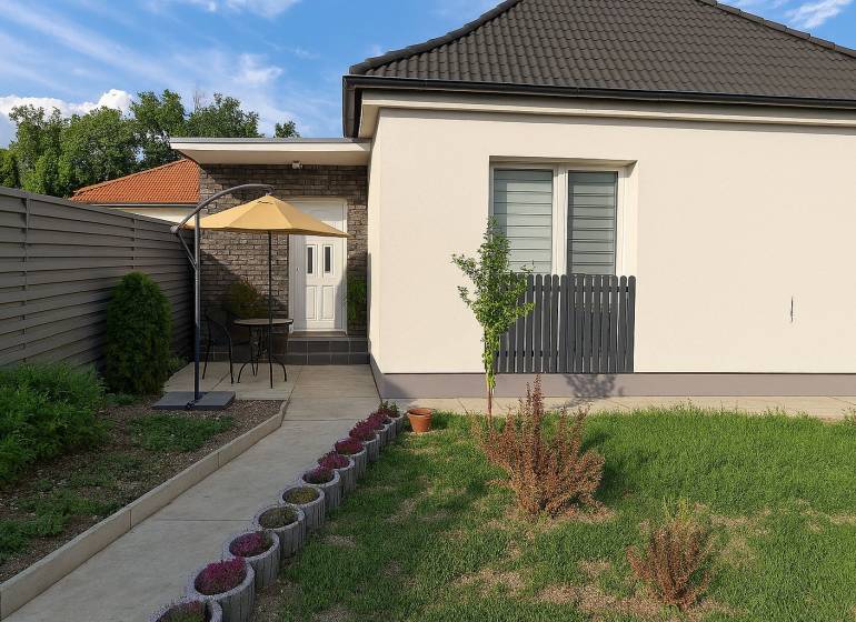 A family house in Horné Saliby with a terrace, fence, and well-maintained garden.