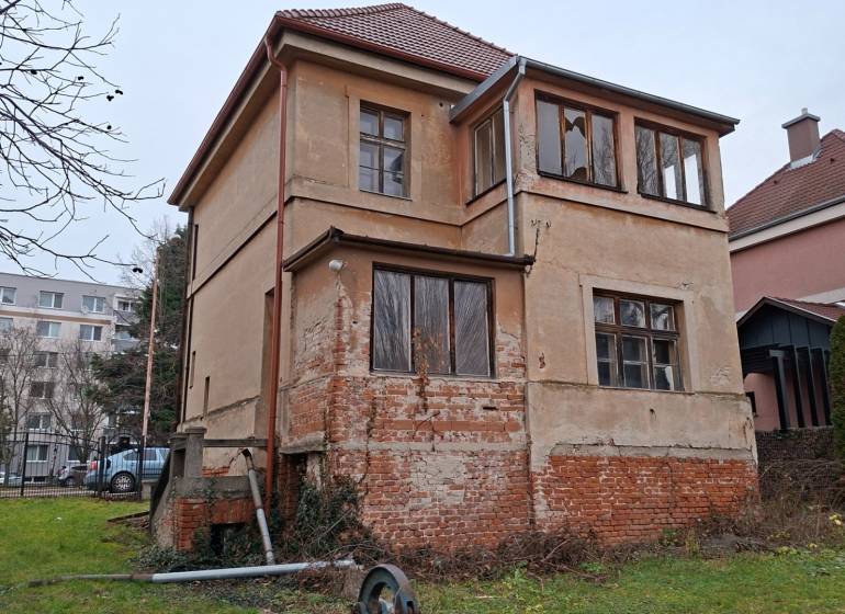 A family house on Levická Street in Vráble with plaster and a brick foundation.