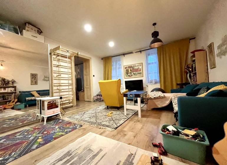 Living room in a family house with a wooden decor floor and various decorations.
