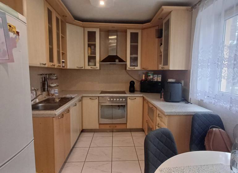 A kitchen in a 2-room apartment with corner cabinets and a spacious countertop.