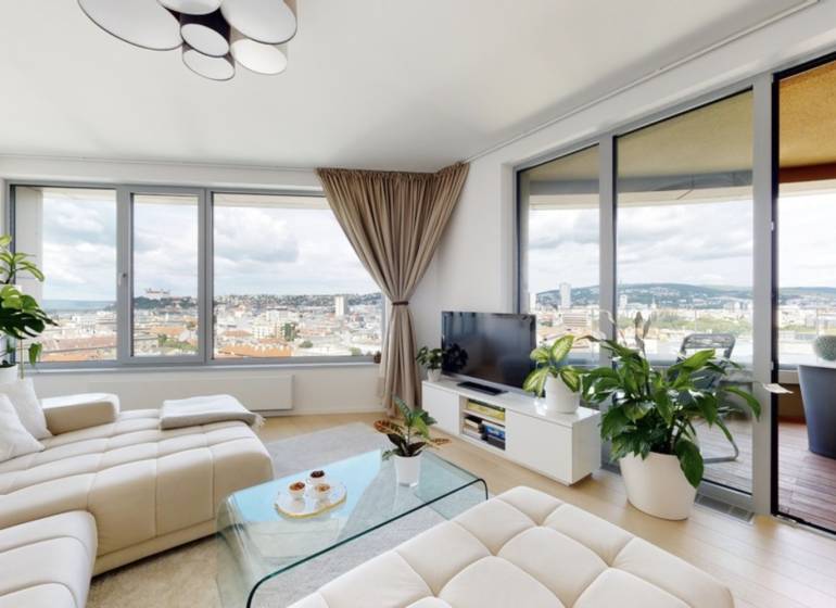 Living room in a 3-room apartment with large windows, view of Bratislava - Old Town.