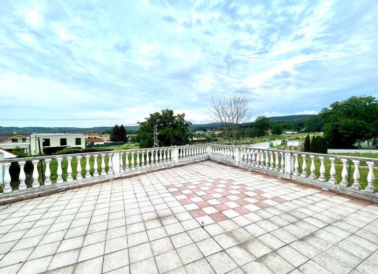 The terrace of a family house on Pútnická Street in Bratislava - Záhorská Bystrica with a view of greenery.