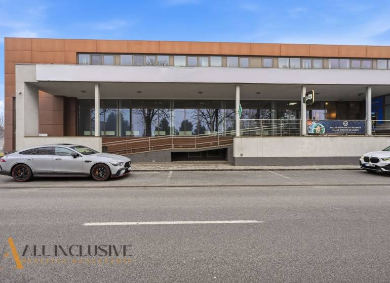 Commercial premises in Topoľníky with a modern building and parking in front of the entrance.