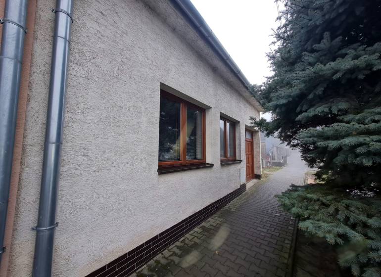 A family house on 1st May Square in Chtelnica with a landscaped exterior and a tree.