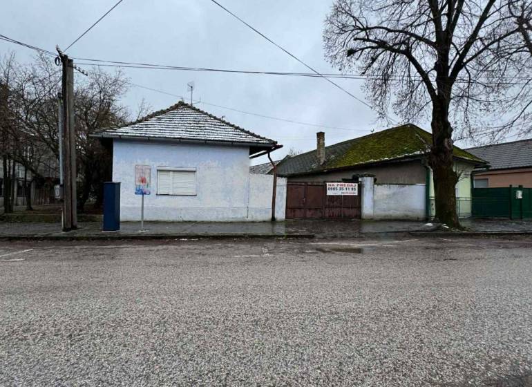 A family house on Komenského Street in Šurany, with a white facade and a tiled roof.
