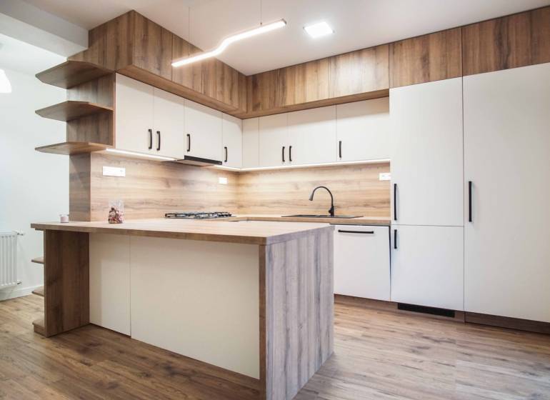 A kitchen unit with a wooden decor floor in a family house.