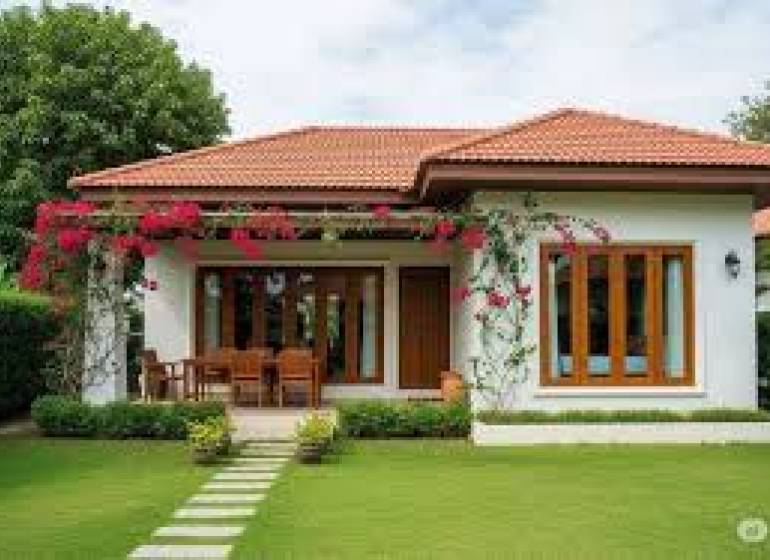 A family house in Liptovský Mikuláš with a lawn and a terrace, decorated with climbing plants.