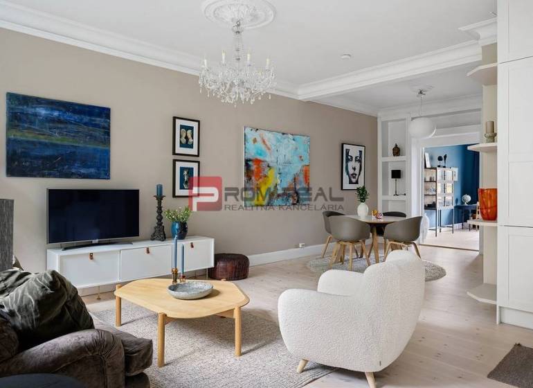 Living room in a 3-room apartment, light flooring with wood decor, stylish decorations.