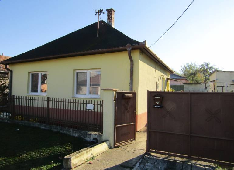 A family house on Mechenice Street in the town of Podhorany, with a front yard and a gate.