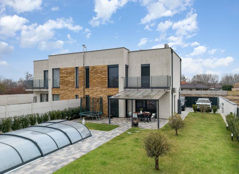 A family house in Dunajský Klátov with a terrace, swimming pool, and well-maintained garden.