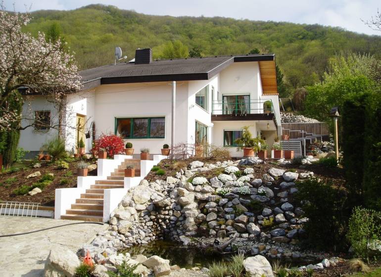 A family house in Hainburg an der Donau with a well-maintained garden and stone landscaping.
