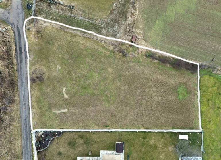 Aerial view of residential plots in the town of Kuzmice, on a quiet street.