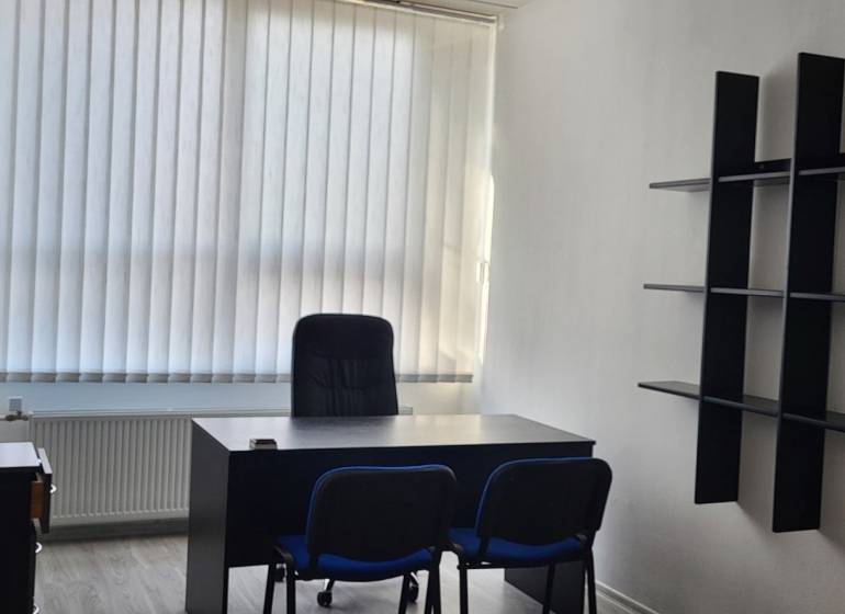 Offices with furniture, a window with vertical blinds, and a floor with a wood decor.