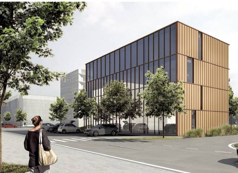 Recreational plots, Dolnozemská Street in Bratislava - Petržalka with trees and a modern building.