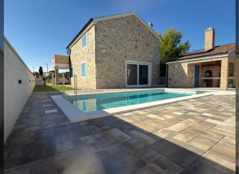 Family house in Vrsi with stone cladding and a pool on the terrace on Vrsi street.