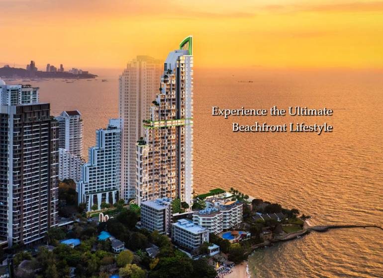 A view of apartment construction in Pattaya with a sea view at sunset.