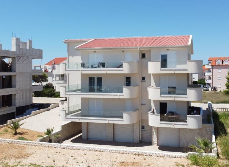 A recreational apartment in Povljana with balconies and a modern facade design.