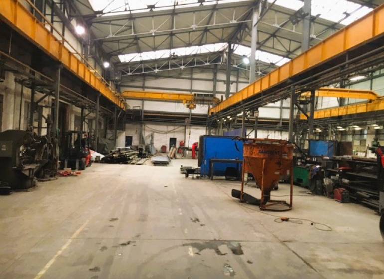Production premises in Spišská Nová Ves with high ceilings and industrial equipment.
