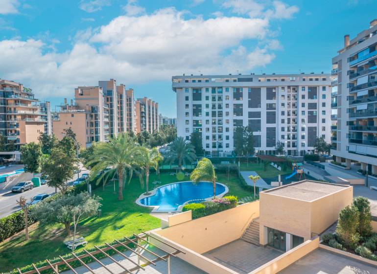 View of residential buildings and a pool in Alicante, 2-bedroom apartment.