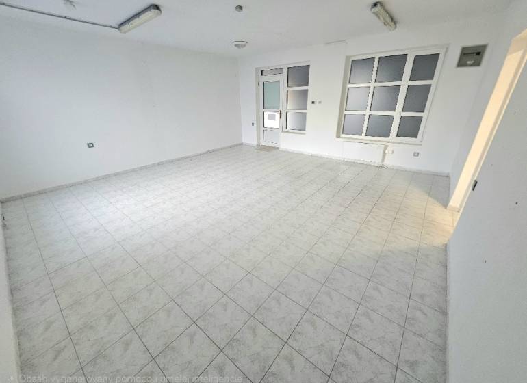 White interior of commercial spaces with tiled flooring and large windows.