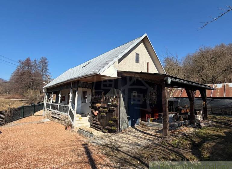 A family house in Ratkovské Bystré with a gable roof and a wooden veranda.