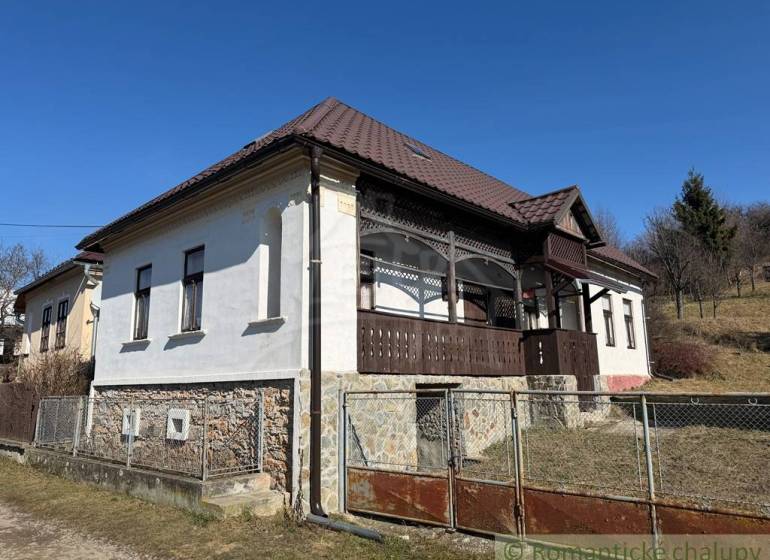 A family house in Lipovec with historical details, stone, and distinctive wooden veranda decor.