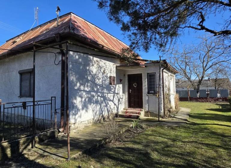A family house in Pavlovce nad Uhom with a metal roof and a garden.