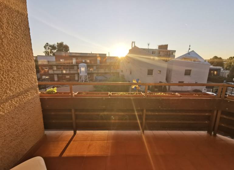 The balcony of a 4-room apartment on Priekopnícka Street in Bratislava - Podunajské Biskupice at sunset.