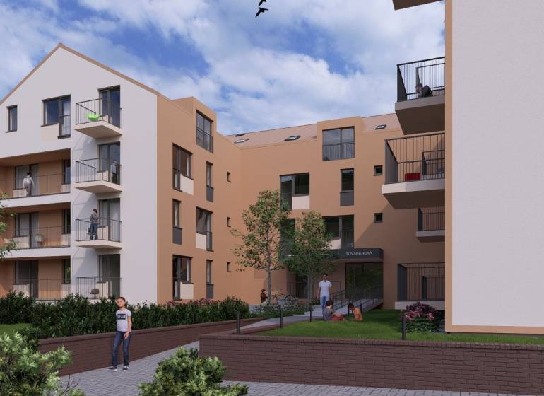 The exterior of a building with multi-storey apartments in the city of Poprad and people on the balconies.